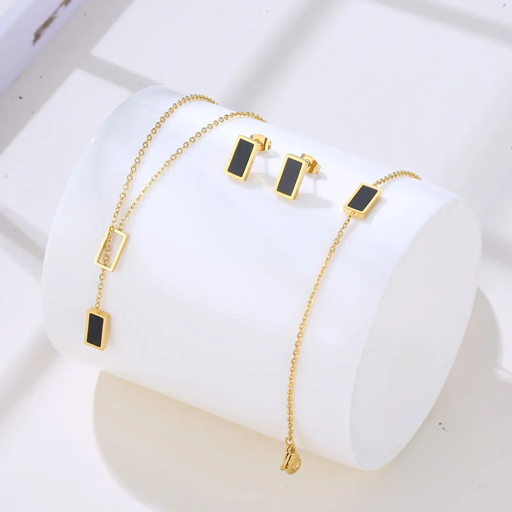 Set “Luce Geometrica” – Bracciale, Orecchini e Collana dorati con ciondolo bianco o nero