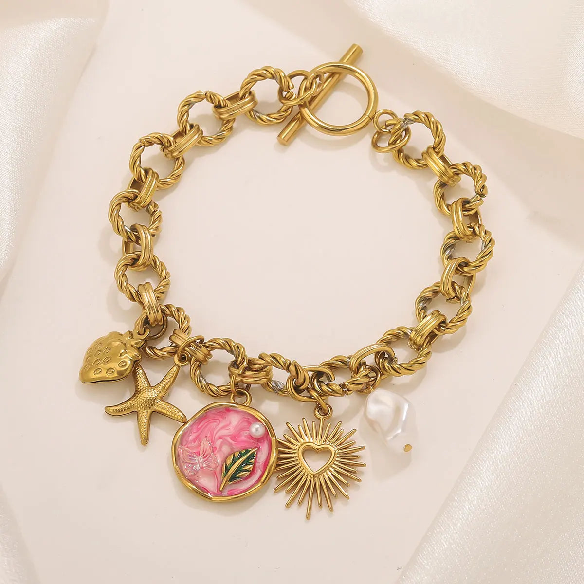 Bracciale bohémien con ciondoli – Stella marina, frutti e fiori